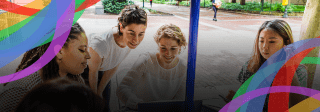 Group of women sitting at an outdoor table and looking at a laptop