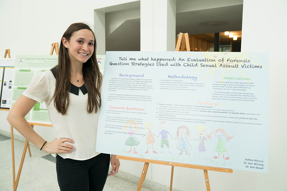 Ashley Marcus poses with thesis poster.