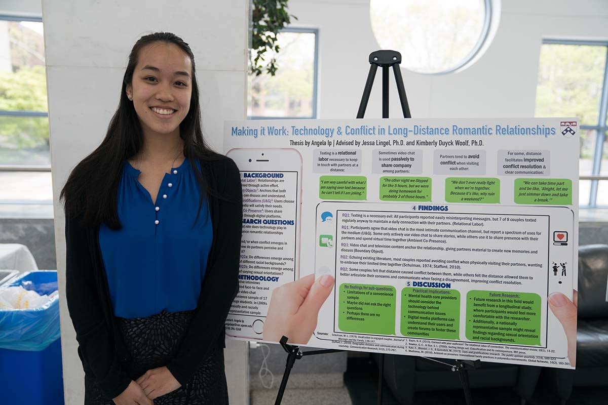 Angela Ip poses with thesis poster.
