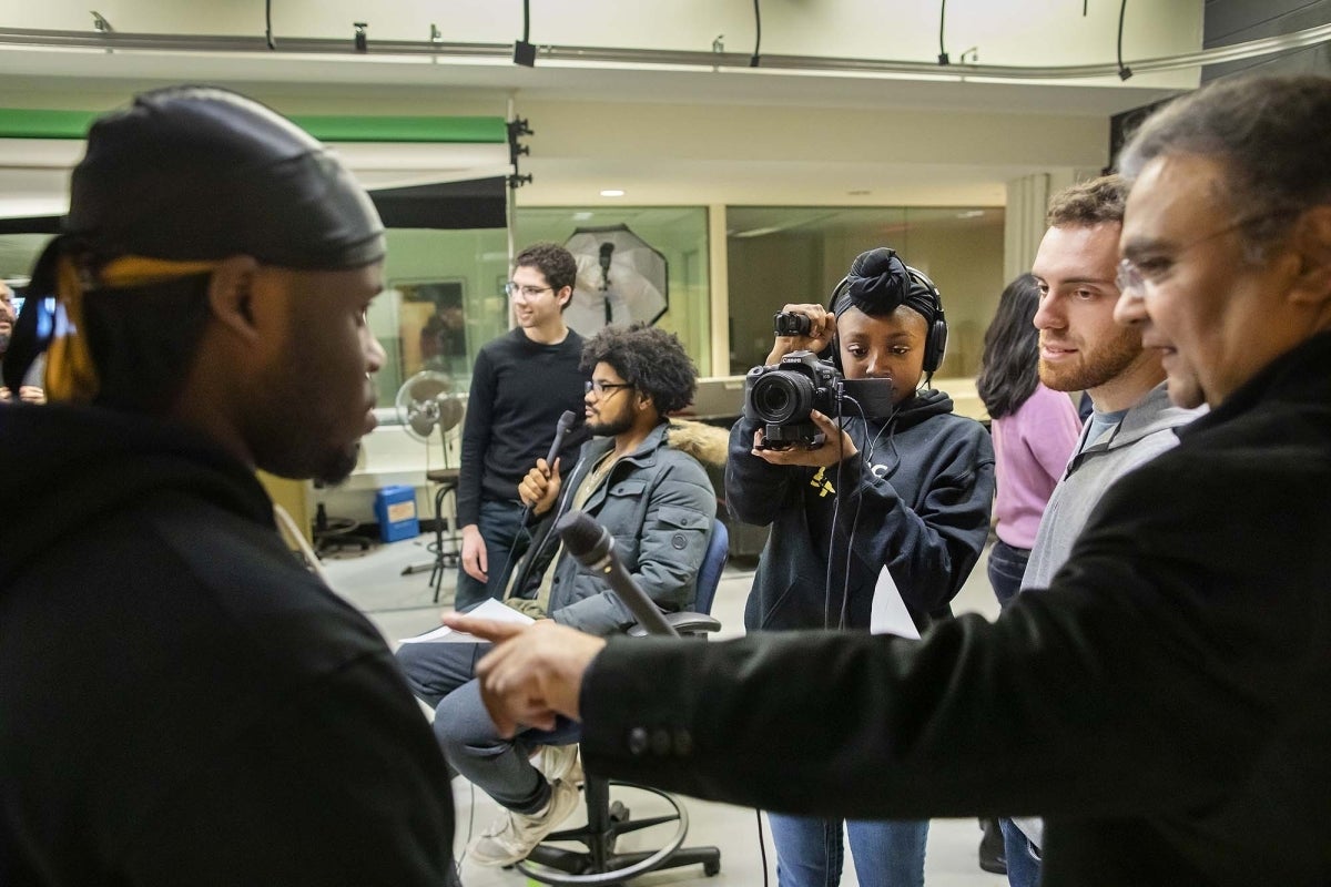 Amitanshu Das instructs students on using film equipment