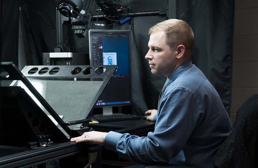 Photo of Overgard operating the double-mounted camera used to digitize the journal