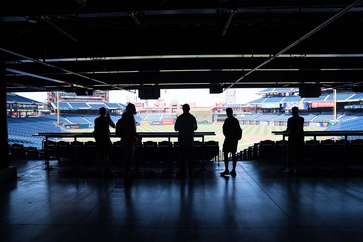 Silhouette of students taking pictures of Citizens Bank Park.