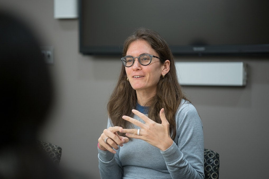 Emily Falk listening to student's presentation