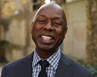 Headshot of Emerson Coleman in a suit and tie