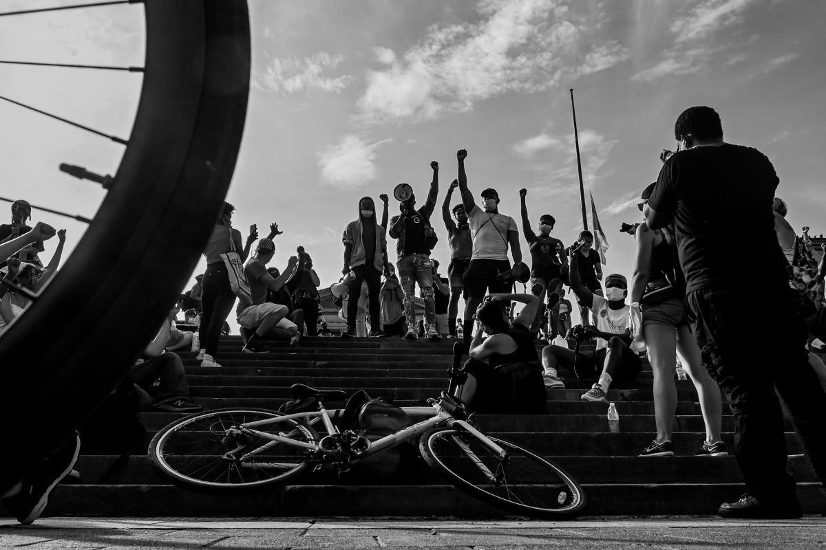 Protesters raise their fists on the steps of the Philadelphia Museum of Art during a protest for George Floyd on June 4, 2020.