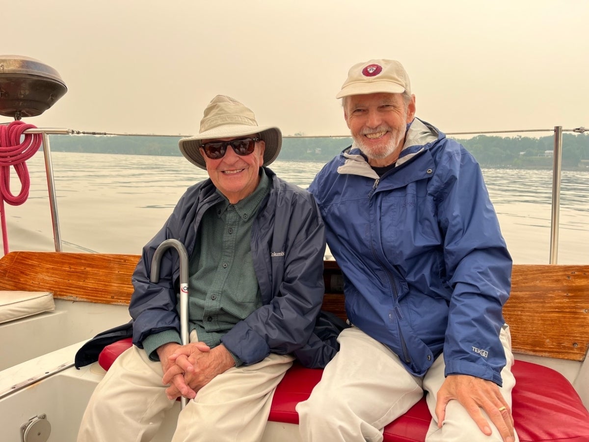 Two men seated on a boat