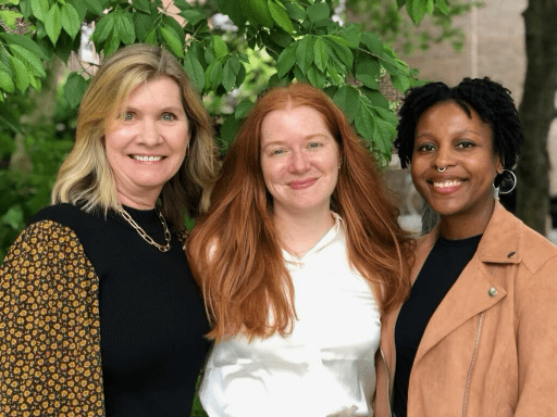 Sarah Banet Weiser smiling with two students