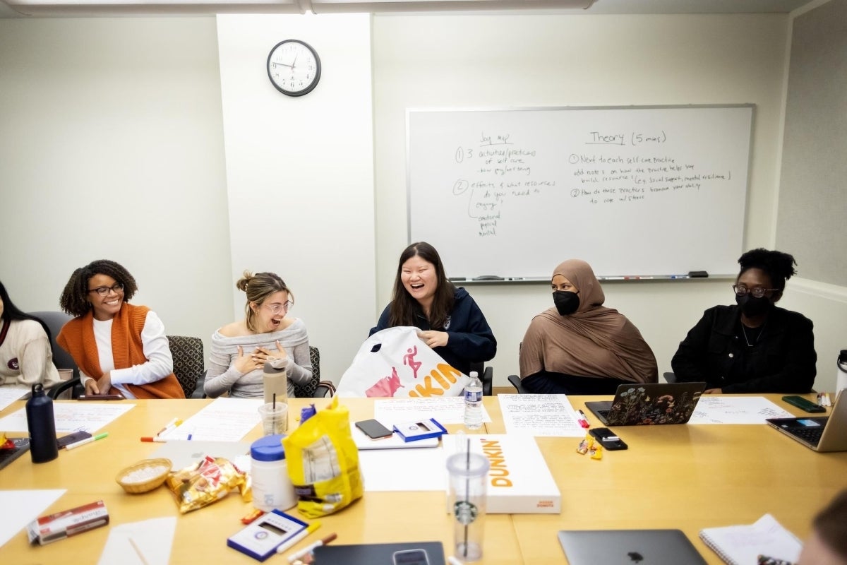 Students sit in a classroom laughing