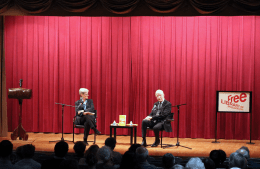 Kathleen Hall Jamieson and Francis Collins sit in chairs on a stage having a discussion