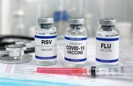 Vials of vaccines for the flu, RSV, and COVID-19