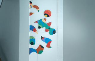 colorful artwork of various abstract shapes on a wall