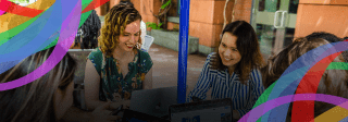 Group of women sitting at an outdoor table on their laptops