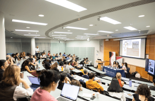 Attendees in a lecture hall at the Annenberg School, listening to a panel discussion