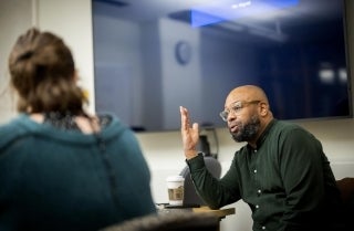 Desmond Patton speaks with a student during the Journey to Joy class.