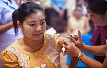 Photo of a woman obtaining a medical shot. Photo credit: CDC