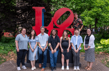 Members of the Health Communication &amp; Equity Lab pose in front of Penn's LOVE statue