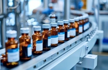 COVID-19 Vaccine Bottles with Branded Labels Move on Pharmaceutical Conveyor Belt in Research Lab