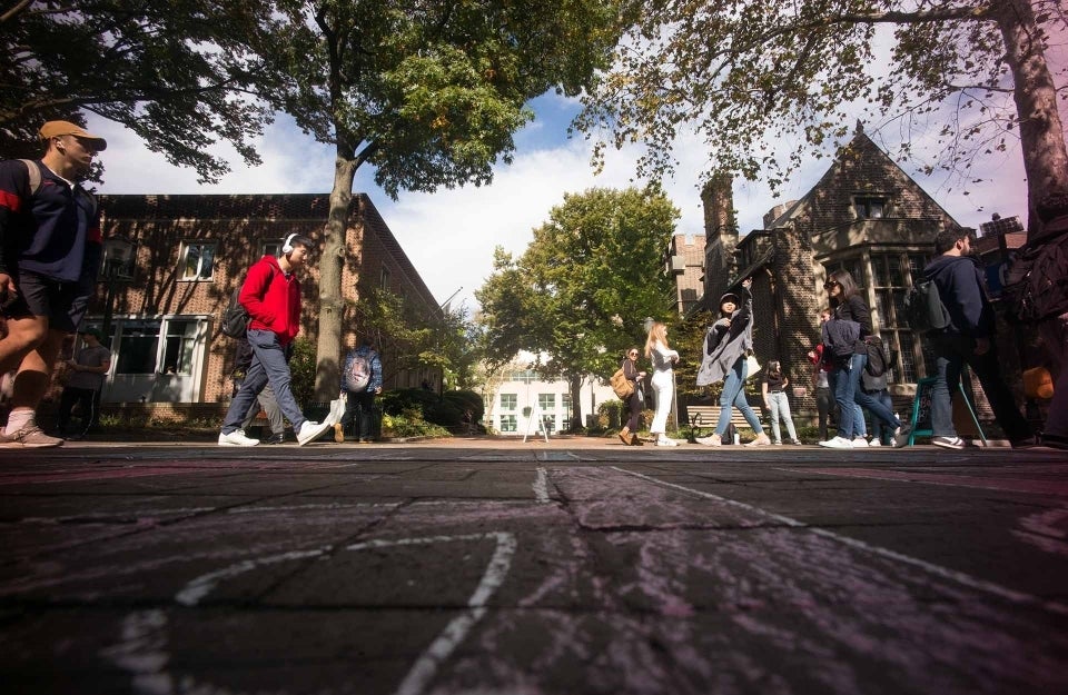 Students walking along Locust Walk as viewed from low angle