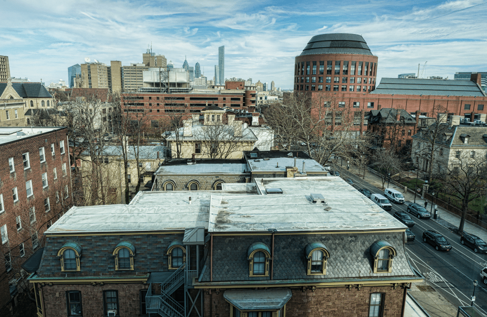 aerial view of Penn's campus during the day, with many buildings, trees, and cars