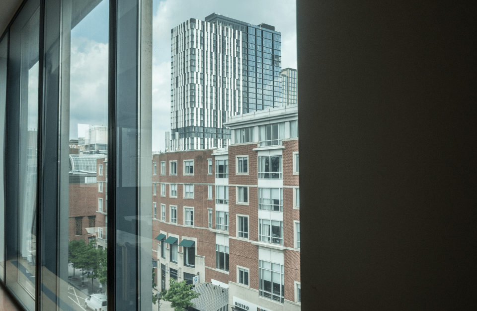 angled shot of glass panels on a bright day with a view of buildings from a high level