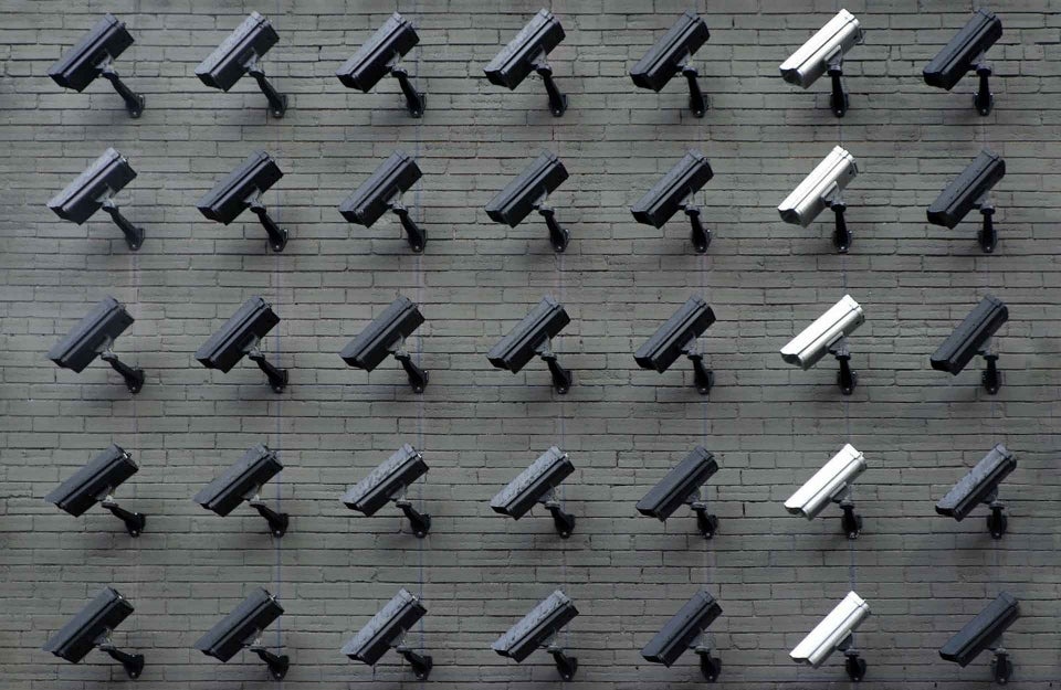 Surveillance cameras arranged in a 5x7 array, photo credit Lianhao Qu / Unsplash