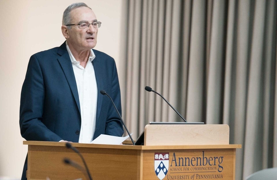 Lecturer Eytan Gilboa at the podium during the mock press conference