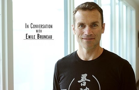 Photo of Emile Bruneau smiling in front of a window