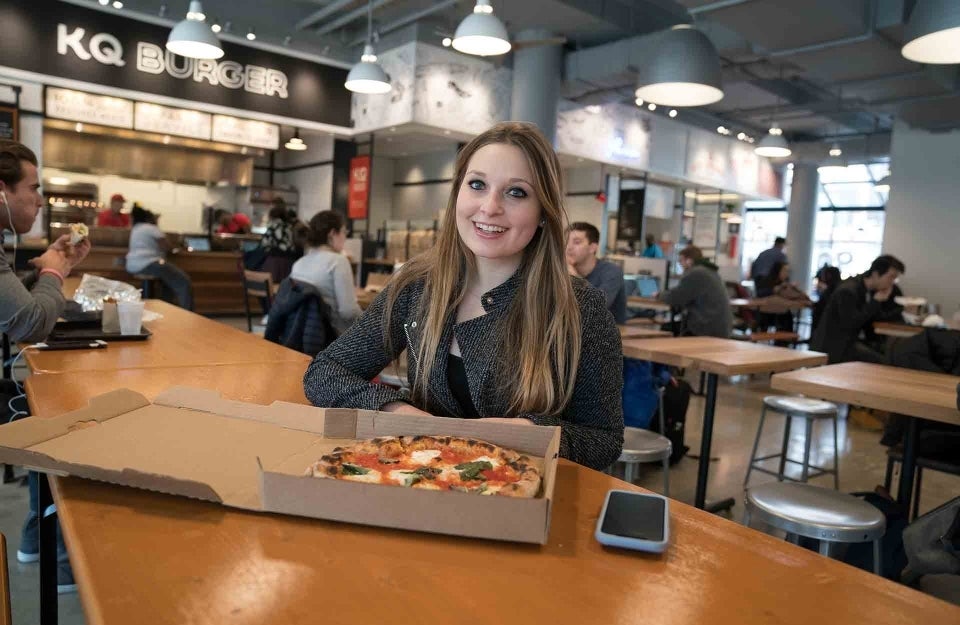 Bevan Cohen poses with pizza in front of her