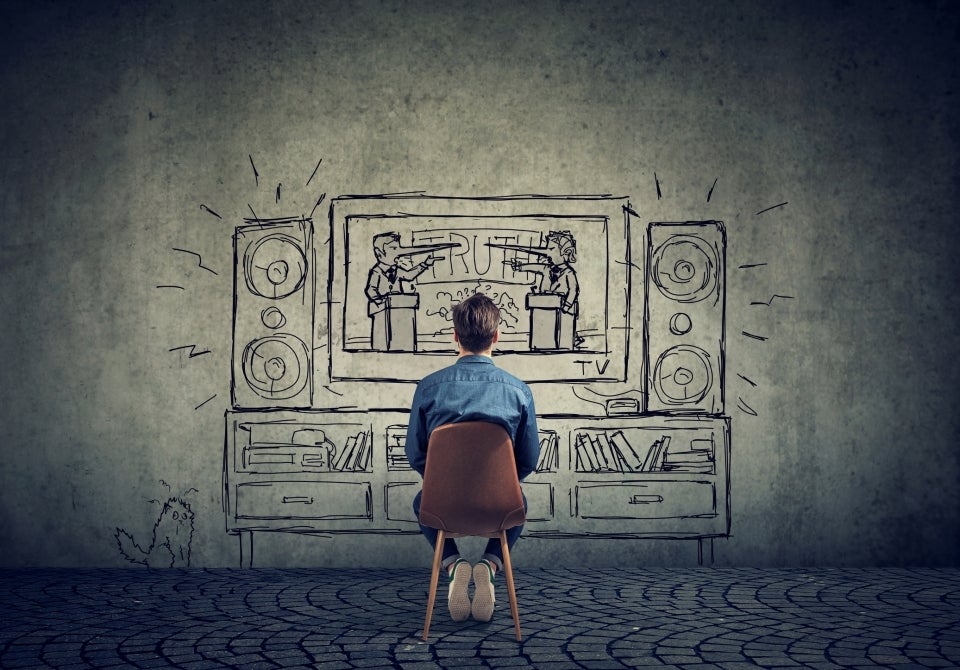 Person sitting in front of wall art of debate on television streets