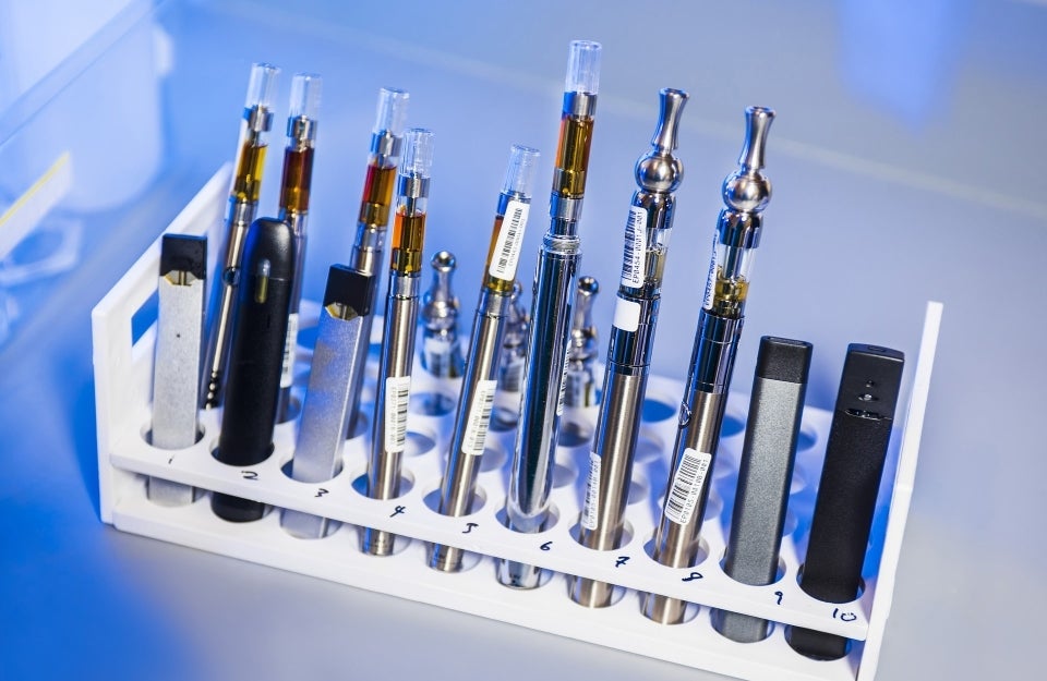 This image depicted a test tube rack that had been stocked with examples of various electronic cigarettes; Photo by CDC on Unsplash