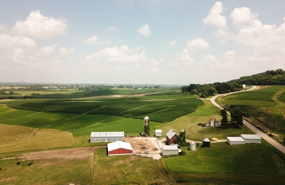 view of a farm in a rural area; Photo by John Reed on Unsplash