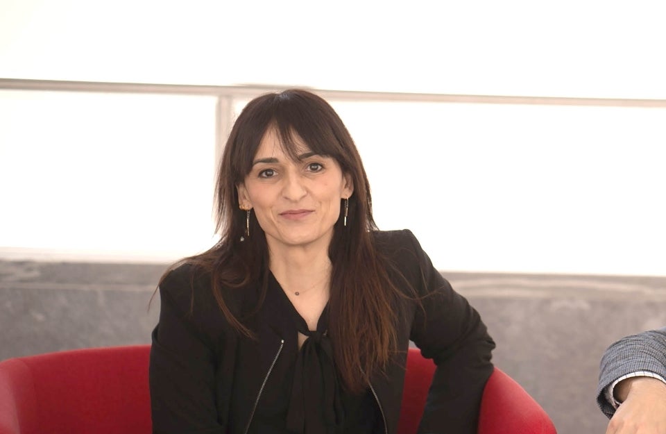 Sandra Gonzalez-Bailon seated in a red chair