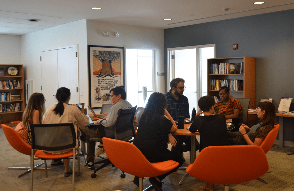 CARGC fellows gathered at round tables in two small groups