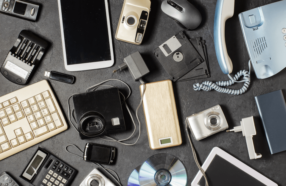 Various electronic devices on a black background