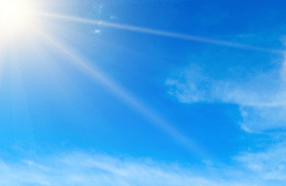 Bright midday sun illuminates a blue sky