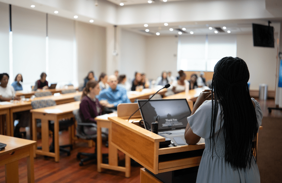 A student makes a presentation to a full class