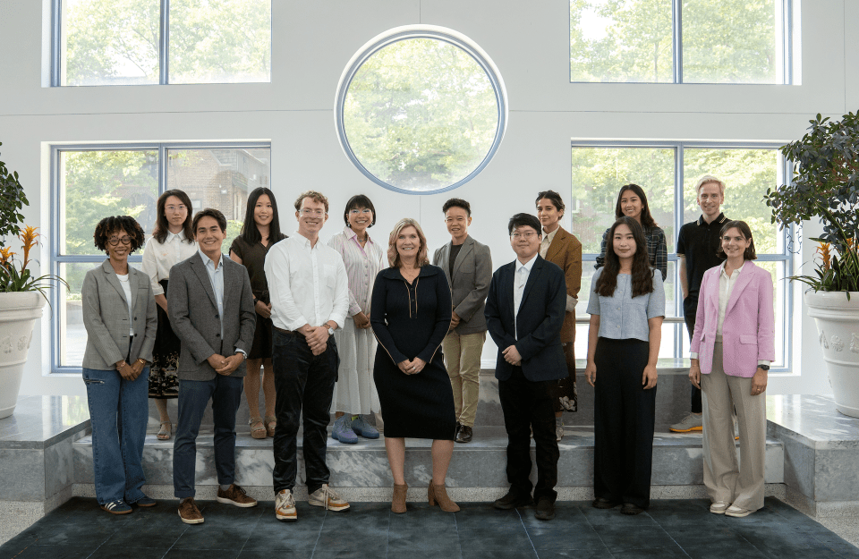 The 2024 Annenberg School doctoral cohort pose with Dean Sarah Banet-Weiser in the Annenberg School Plaza