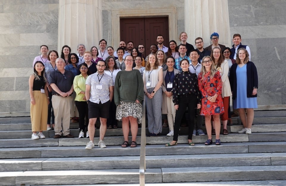 The “Community for Rigor” team poses on a set of stairs