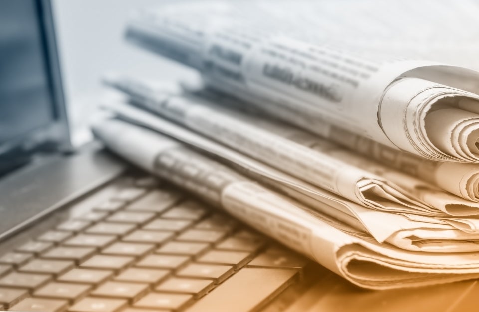 Folded stack of Newspapers on laptop