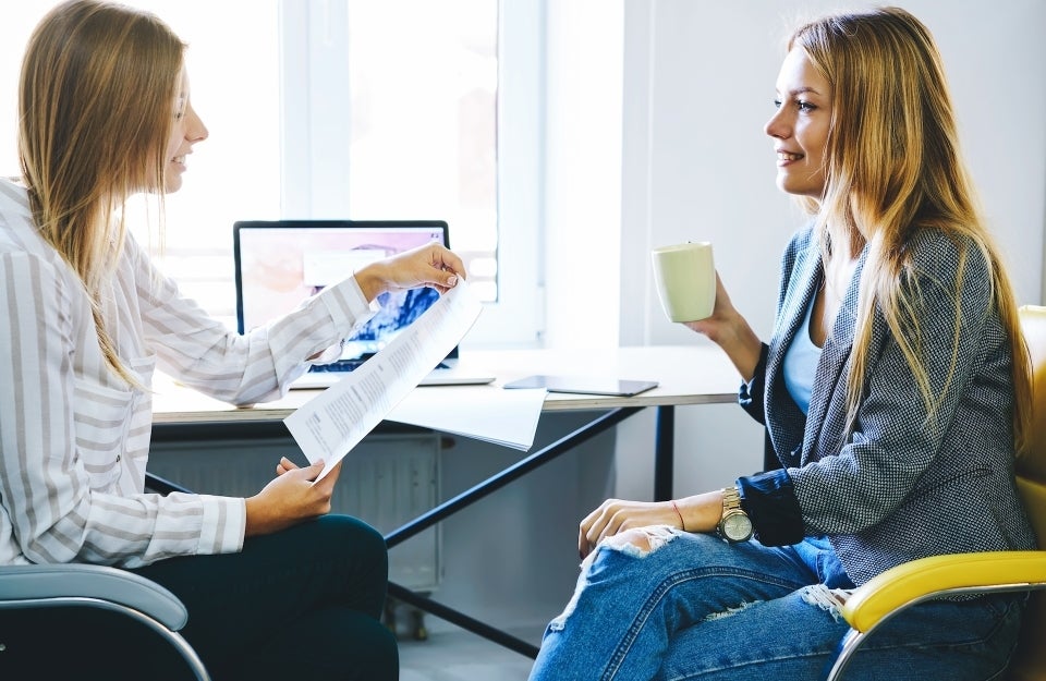 Coworkers sitting in office having a discussion face to face