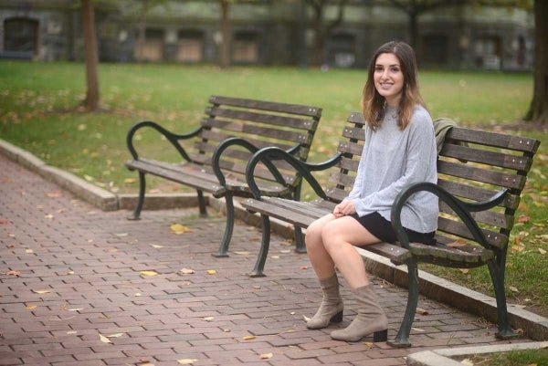 Elizabeth Heit sits on a bench