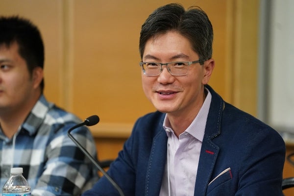 Andy Tan seated and smiling at the camera