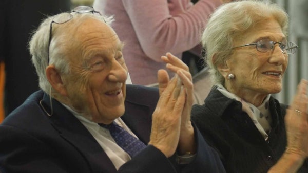 Elihu and Ruth Katz seated and clapping