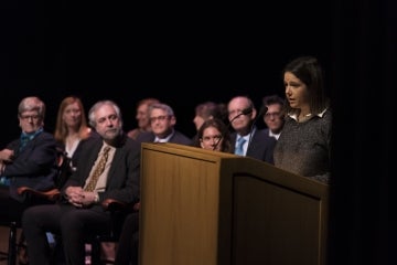 Ashley Parker behind a podium, speaking to the audience